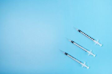 blood sugar regulation, insulin syringes on a blue background,copy space