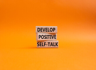 Develop positive self-talk symbol. Concept words Develop positive self-talk on wooden blocks. Beautiful orange background. Business and Develop positive self-talk concept. Copy space