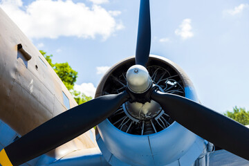 Old Military Plane From Second World War Close Up detail With Blue Sky and White Clouds in the...