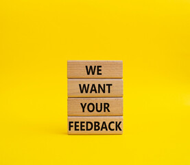 We want your feedback symbol. Wooden blocks with words We want your feedback. Beautiful yellow background. We want your feedback concept. Copy space.