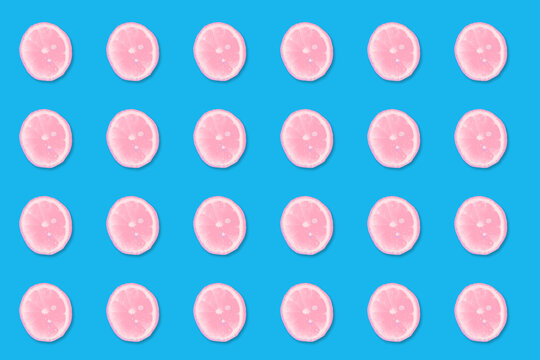 Pink Lemon Slices On A Blue Background.