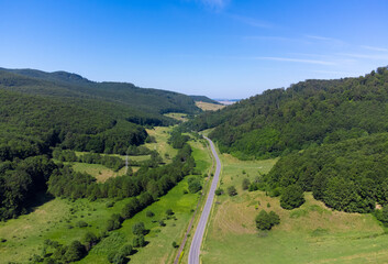 Fototapeta na wymiar landscape of a road among hills and forests seen from above