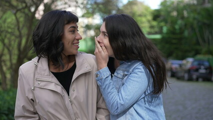 Fototapeta premium Female friend reacting with shock and surprise to news while walking outside. Two friends happy reaction