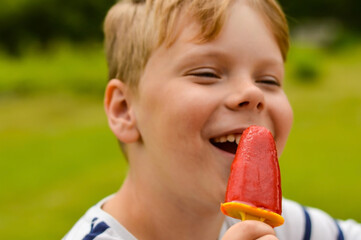 Selective focus of a hand holding homemade strawberry ice cream.