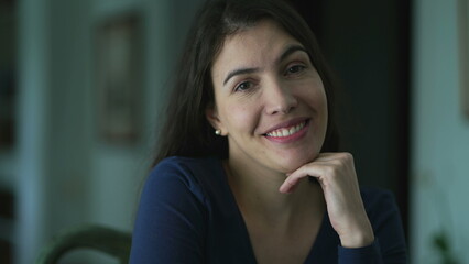 Fototapeta na wymiar Portrait of a smiling 30s female looking at camera. Happy positive woman at home