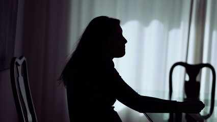 One pensive woman silhouette thinking about problems. Person suffering alone