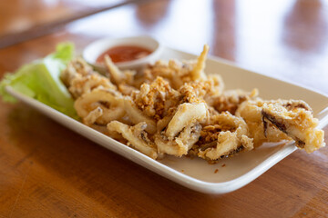 fried squids or octopus with tomato sauce.