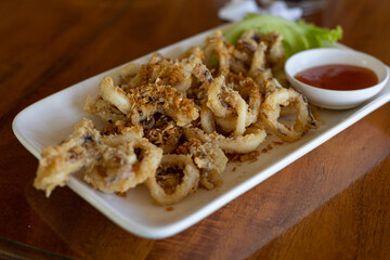 fried squids or octopus with tomato sauce.