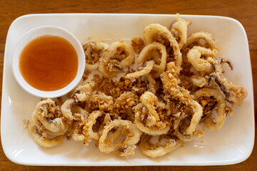 fried squids or octopus with tomato sauce.
