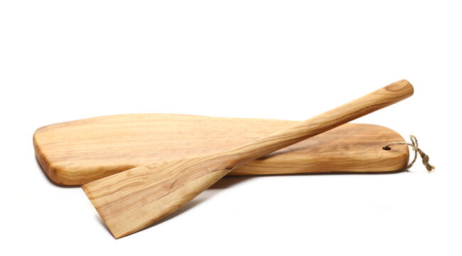 Wooden chopping board from olive wood and wooden spoon isolated on white, side view  