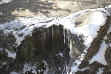 icicles on a rock covered in snow on the Rocky Mountains 
