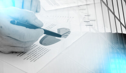 Businessman checking financial charts; multiple exposure