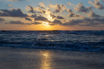 Sunset on the Mediterranean coast. Natural landscape. Mediterranean nature. Blue sky and yellow sunlight. Israel.