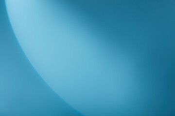 A semicircle of lights hits a light blue background