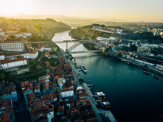 Fototapeta na wymiar Porto Portugal Aerial View. Dom Luis Bridge at Sunrise. Porto, Portugal. Cityscape of Downtown Touristic Ribeira. Olt Town. Douro River.