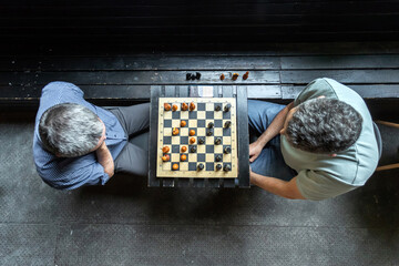 Top view of two people playing chess