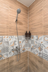 Yellow shower room with shelf and jars for shampoo and liquid soap