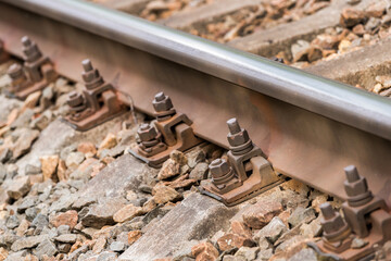 Fastening railroad tracks to sleepers with bolts