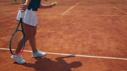 Concept of professional sport and healthy lifestyle closeup to the camera tennis player woman hitting the ball on the floor then hit hard the ball with the racket outdoor on the tennis court - Powered by Adobe