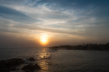 Fototapeta na wymiar The setting sun over the sea horizon