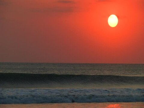 Sunset at Kuta beach with wave crashing