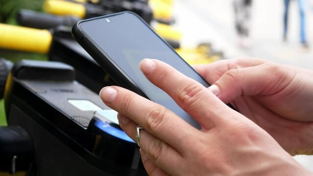 Electric scooter in a shared parking lot, an application for a tourist phone. Alternative modes of transport using ecotransport