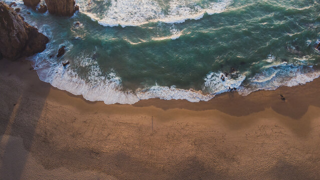 Shore near sea with cliffs at sunset time