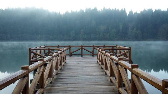 Wooden pier in Savsat Karagol Black lake in Eastern Black Sea region with morning evaporation. Savsat Karagol lake is a large trout lake in the forest in Artvin, Turkey