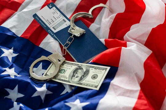 International passport with handcuffs on USA flag background