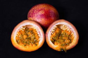 Set of fresh passion fruit isolated on black background