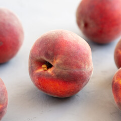 Raw Organic Yellow Peaches on a gray background, side view. Close-up.
