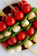 Homemade caprese skewer appetizer on a plate, top view. Flat lay, overhead, from above. Close-up.
