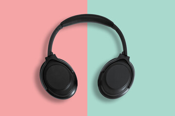 Computer headphones. Black headphones on a white background. The concept of listening to music, creating audio, music. Computer work, abstraction and minimalist style.