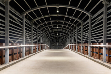an eerie passageway of steel and light