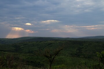 Naklejka premium sunset panorama of green hills at the viewpoint at Hluhluwe iMfolozi Game Reserve