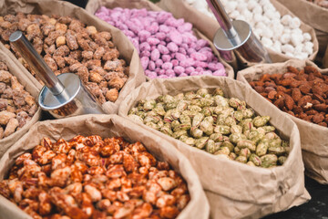 Different types of nuts in paper bags are sold in the street market