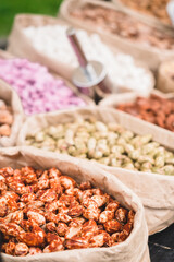 Different types of nuts in paper bags are sold in the street market