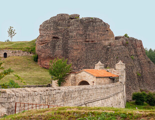 This place called  Belogradchic Rocks is in Bulgaria. Centuries old rock look like figures or appear like characters . Climb the stairs to the top or look at the gatehouse of the old fortress.