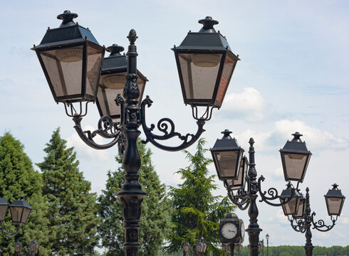 Lampposts line the street of a shopping avenue or plaza. The image was taken in Viden, Bulgaria, a town on the Danube River in Eastern Europe. Look up to see the sky.