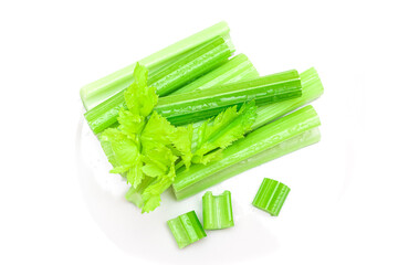 Fresh Chopped Celery Sticks and Slices with Leaves and Water Drops Isolated on White Background. Vegan and Vegetarian Culture. Raw Food. Healthy Diet with Negative Calorie Content