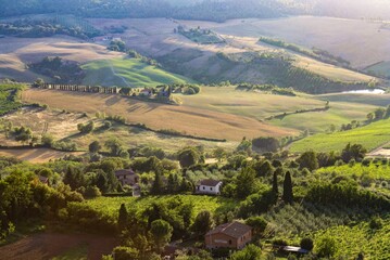 
Tuscany landscape at sunrise. Typical for the Tuscan region farmhouse, hills, vineyard. Italy
