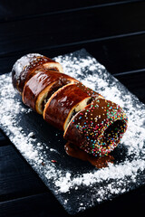 Trdelnik is a traditional sweet cake made from yeast dough held around a stick, then fried and sprinkled with sugar