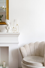 Fototapeta premium Beige armchair and decorative fireplace in living room