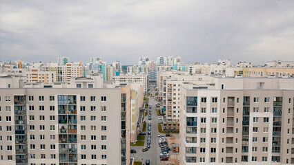 Summer landscape of a new city district on a summer sunny day. Video. Aerial view of newly built high rise residential houses of white and other bright colors, concept of urbanization.