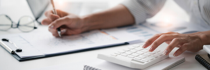 Crop shot of Bookkeeper or financial inspector hands making the report, and calculating. Home finances, investment, economy, saving money, or insurance concept