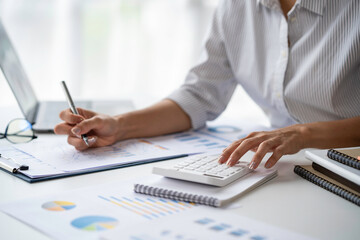 Fototapeta premium Crop shot of Bookkeeper or financial inspector hands making the report, and calculating. Home finances, investment, economy, saving money, or insurance concept