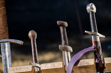 three medieval swords as props for historical re-enactments