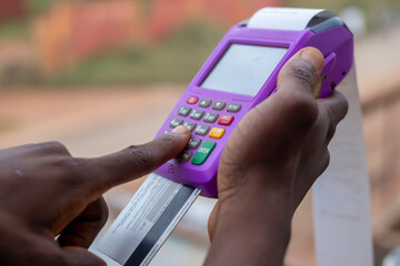 cropped shot of male hand using payment terminal with credit card