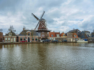 Fototapeta na wymiar A Dutch windmill on lakde side in Meppel, Netherlands