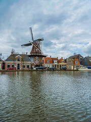 Fototapeta na wymiar A Dutch windmill on lakde side in Meppel, Netherlands
